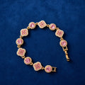 Pink Clover Crystal Bracelet on blue velvet background