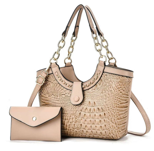 Beige crocodile-style handbag with gold-tone chain-link handles and shoulder strap, pictured beside a beige envelope pouch