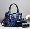 Blue leopard-print handbag with black trim, shown with two smaller black accessories