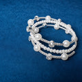 Pearl and Crystal Wrap Bracelet on blue velvet background