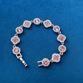 Pink Clover Crystal Bracelet on blue velvet background