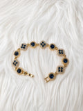Navy Blue Clover Crystal Bracelet on white fur background