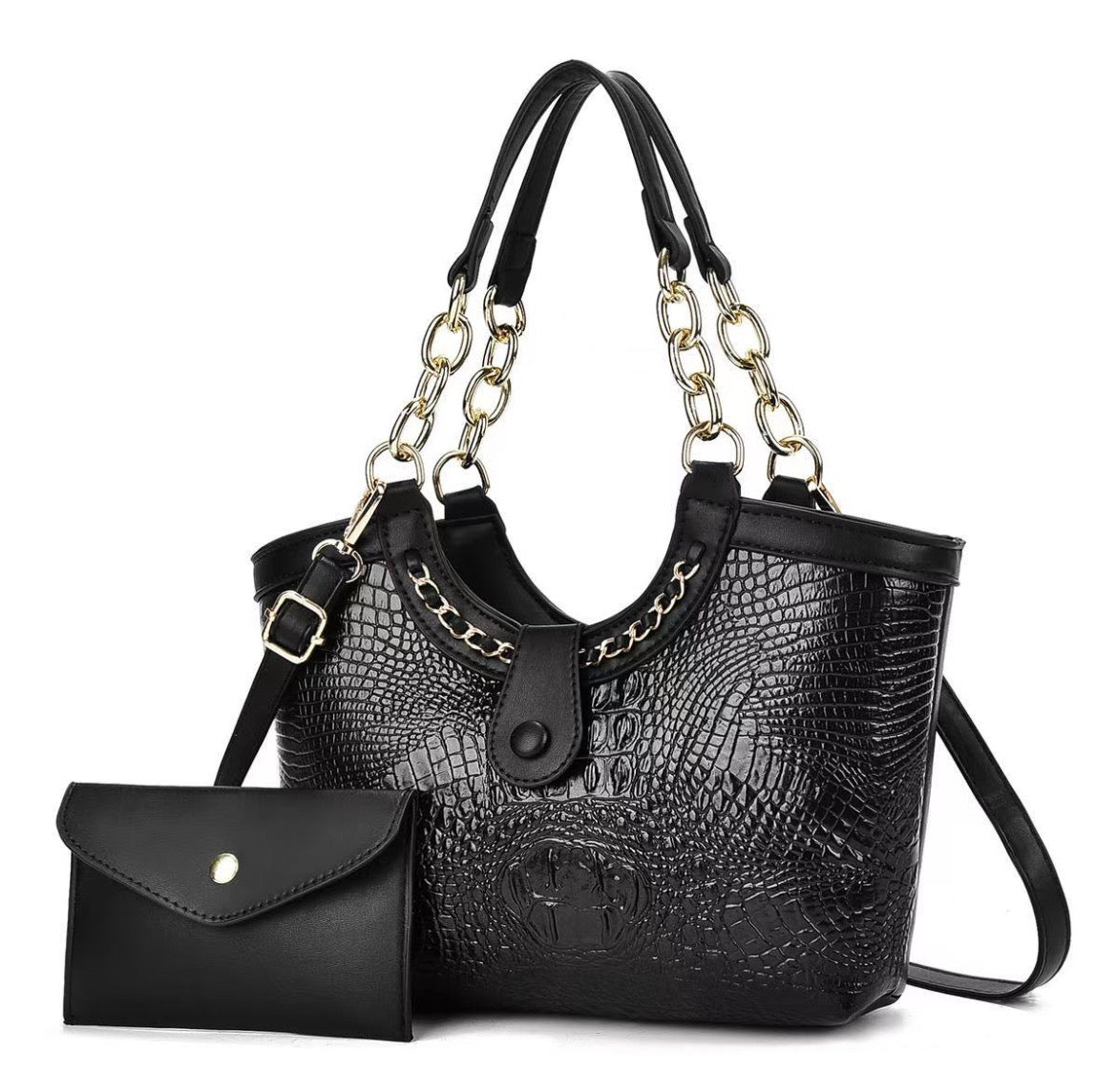 Black crocodile-style handbag with metallic chain-link handles and shoulder strap, pictured beside a black envelope pouch