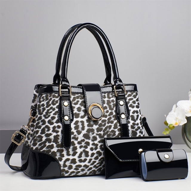 Black and white leopard print handbag with matching black wallet and card case
