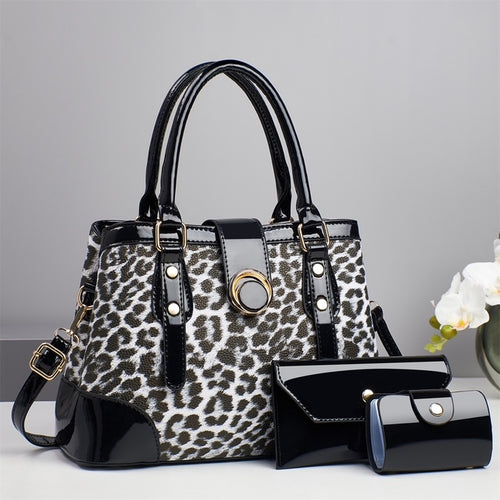 Black and white leopard print handbag with matching black wallet and card case