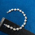 Crystal Cluster Tennis Bracelet on black jewelry card against blue velvet