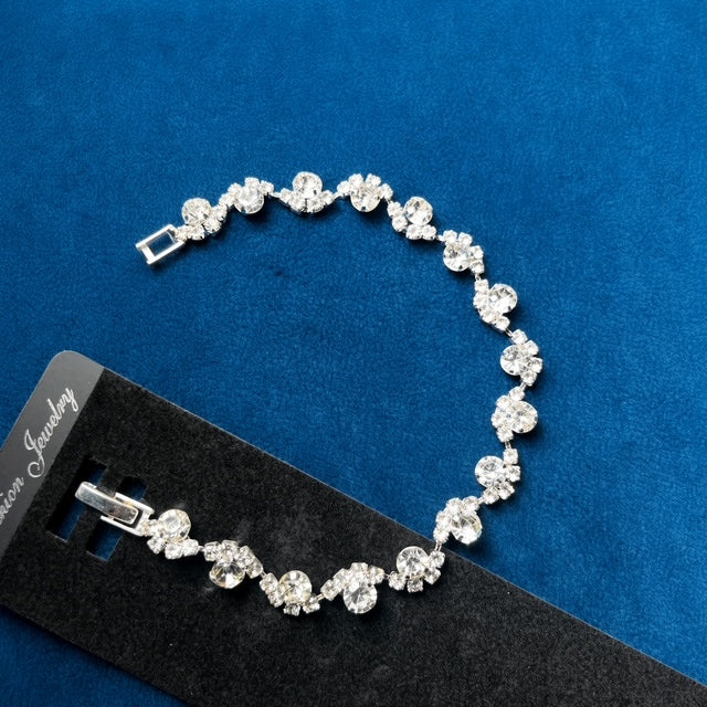 Crystal Cluster Tennis Bracelet on black jewelry card against blue velvet